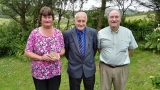 Bernadette Hayes (holding the war medal, grand-niece of Cornelius and current occupant of Cornelius\'s home-place), Cornelius (aka Neilie) Sexton (a cousin of Private Cornelius Sexton and originally also from Scobaun, Castlehaven), and Oliver Murphy (local historian and genealogist).