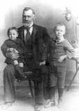 FJ Clarke as a boy, sitting on the knee of his grandfather